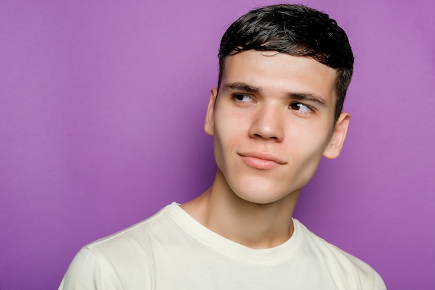 Indoor shot of handsome guy against purple background