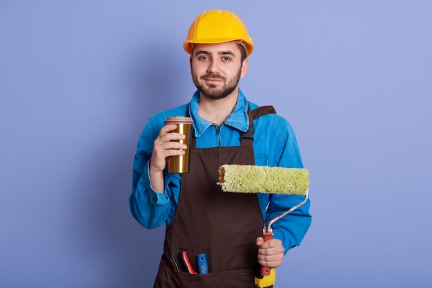 Indoor shot of repairman wearing yellow hardhat