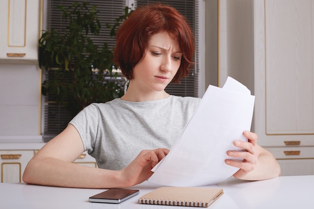 Indoor shot of successful businesswoman has serious expression