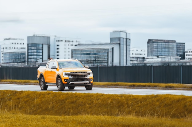 Industrial Backdrop to a Modern Yellow Pickup Truck Journey