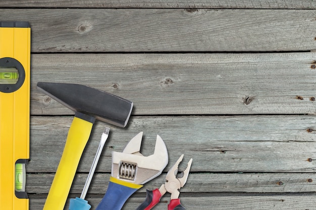 Industrial background with different tools on wooden desk, repair concept