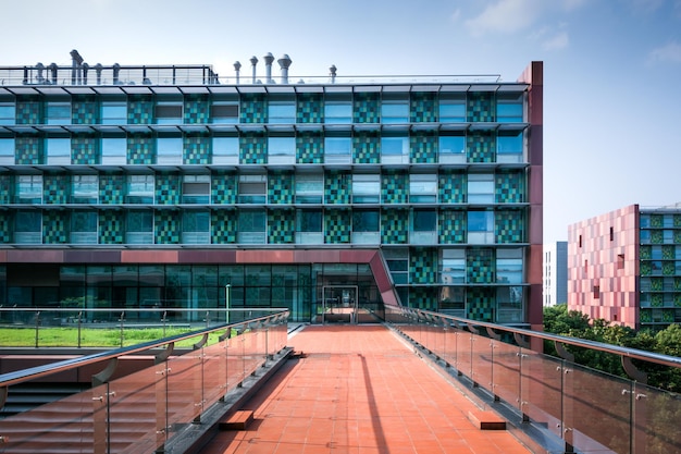 Industrial building exterior and green tree in spring