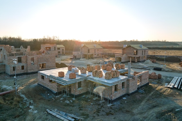 Industrial building site in rural area with residential houses under construction for future sale or leasing Concept of real estate development