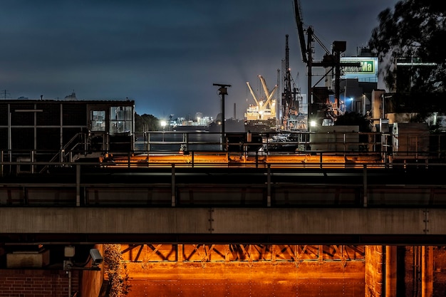 industrial buildings against cloudy sky at night