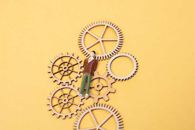 Photo industrial composition man with cogwheel gears