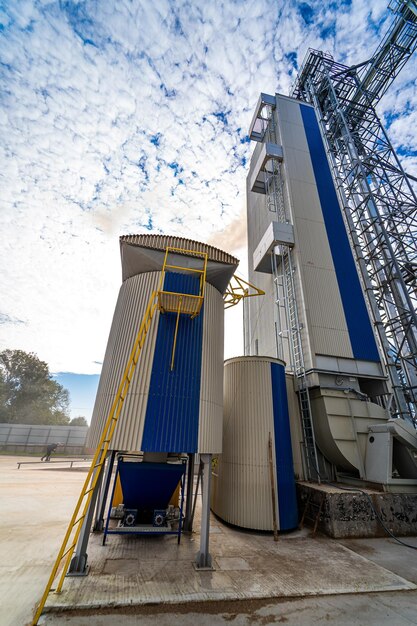 Industrial concrete plant and blue sky with clouds in the background