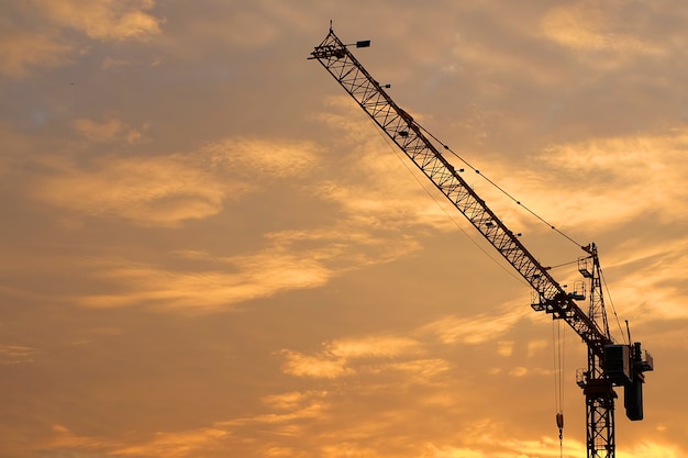 Industrial Construction Cranes and Building Silhouettes at Sunrise