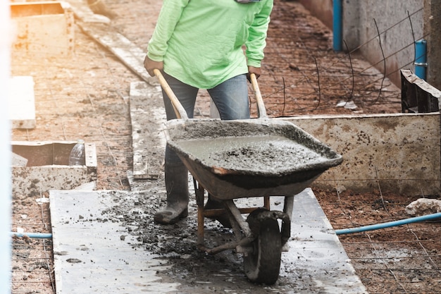 industrial construction labor work concrete mix with cart