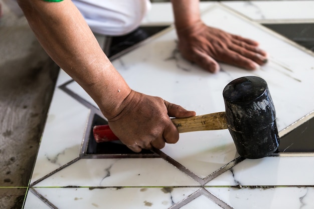 Industrial construction men worker granito tiler builder on floor