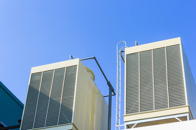 Industrial cooling towers or air cooled chillers on new building factory rooftop