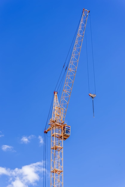 Industrial cranes against the blue sky