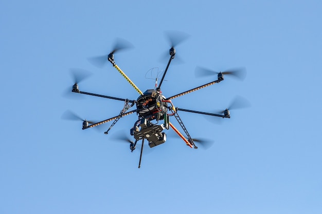 Photo industrial drone with a video camera with blue sky