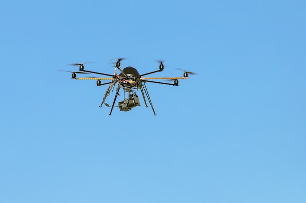 Industrial drone with a video camera with blue sky