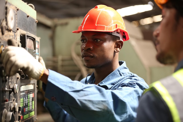 Industrial Engineers in Hard Hats.Work at the Heavy Industry Manufacturing Factory.industrial worker indoors in factory. man working in an industrial factory.