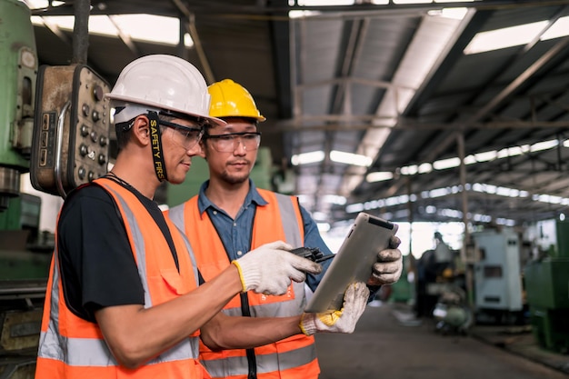 Industrial factory concept. Engineering with technician and worker operating and maintenance of machinery.