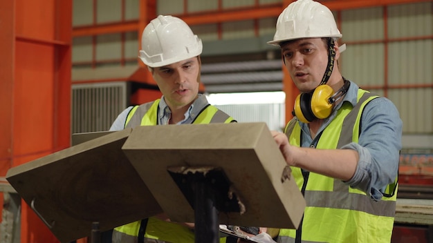 Industrial factory and manufacturing concept. Engineering with technician inspect the production of goods and machines.