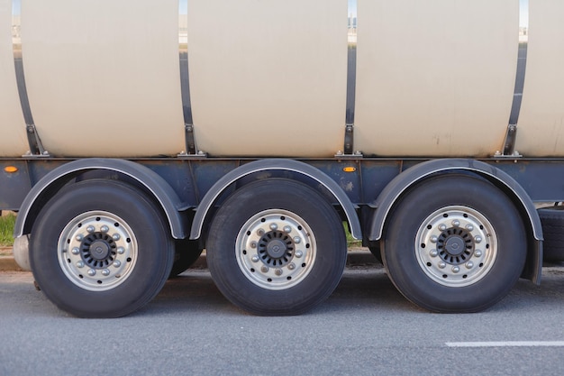 Industrial fuel gas cargo transportation closeup of rear wheel\
of truck rear view with space for text