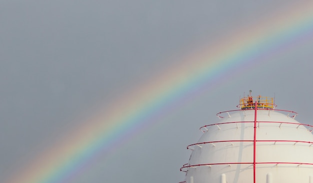 Photo industrial gas storage tank and rainbow