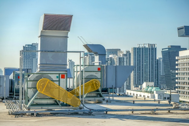 The industrial machine at the rooftop of the huge building.