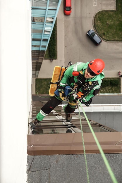 Industrial mountaineering worker during high rise work