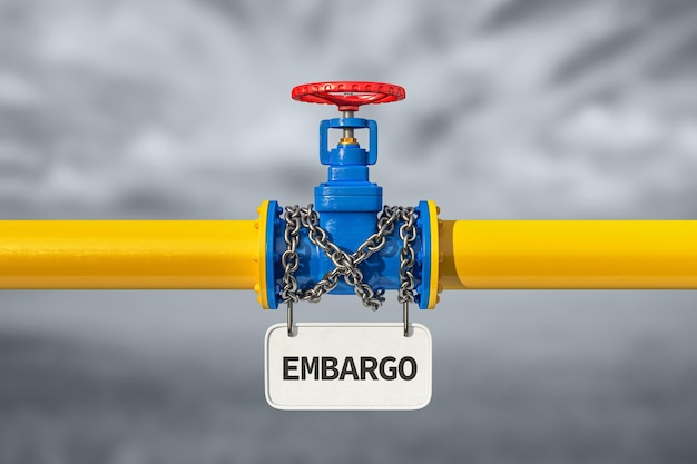 Industrial pipelines and valves with red wheels with chain and white blank sign embargo