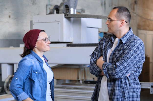 Industrial portrait of two working men and woman