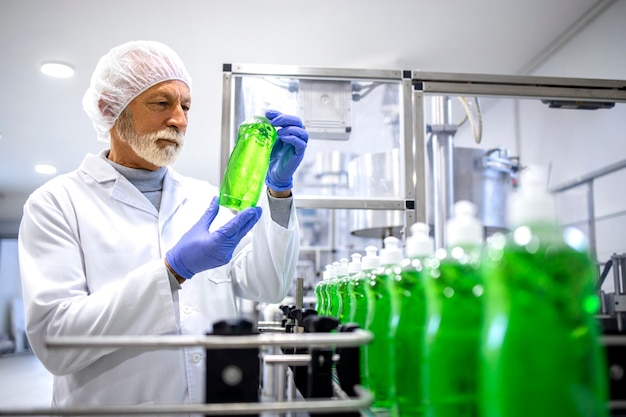 Photo industrial production of cleaning chemicals and factory worker checking quality of detergents