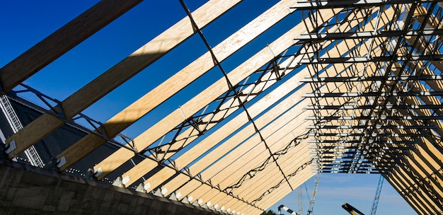 Industrial rafter system. Wooden beam. Construction of an industrial building. Building Technologies.