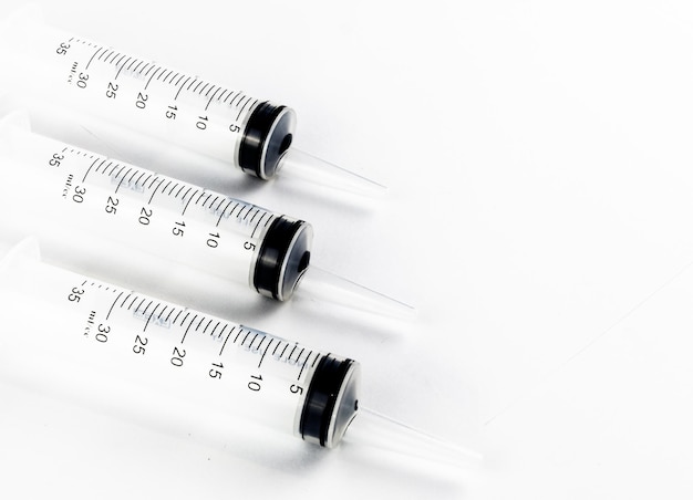 Industrial tapered tip syringes in a row