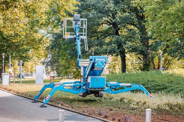 Industrial telescopic unmanned crane standing on hydraulic support legs like a spider at a city park