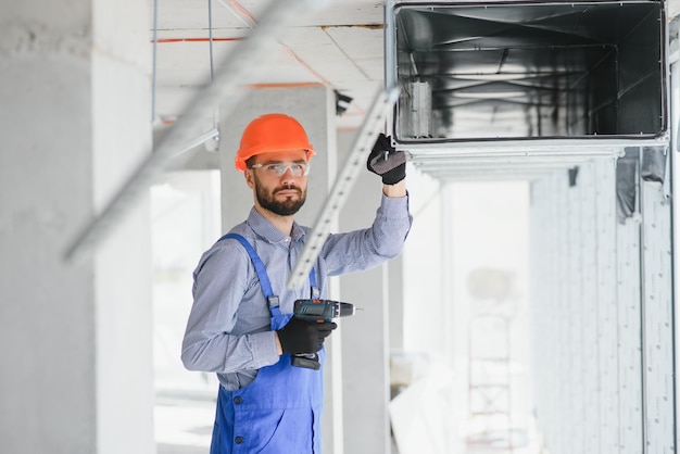 Industrial Theme Warehouse Heating and Cooling System Installation by Professional Caucasian Technician Commercial Building Ventilation Rectangle Canals Air Distribution