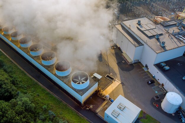 Industrial thermal power station smoke stacks with pollution of steam