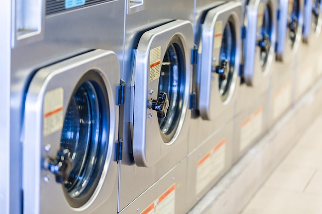 Industrial washing machines in a public laundromat.