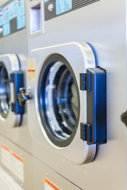 Industrial washing machines in a public laundromat.