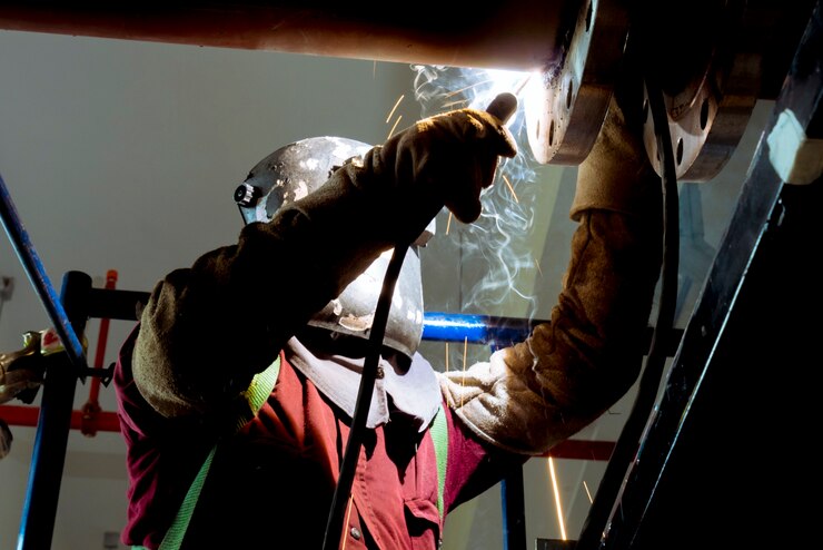 Photo industrial welder welding fabricated construction in factory welding process