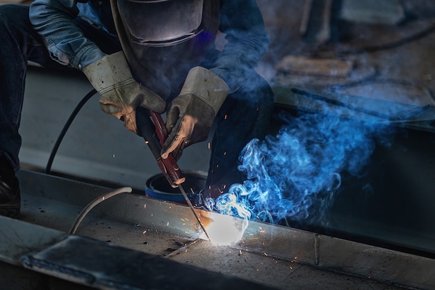 Industrial Worker at the factory Steel welding closeup, Welder 