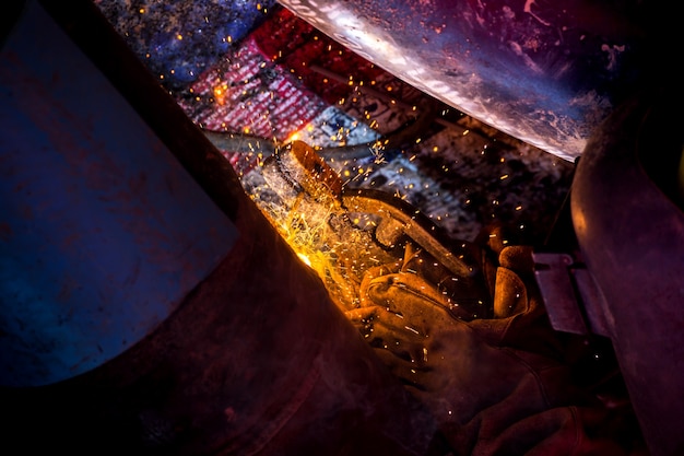 Industrial Worker at the factory welding closeup