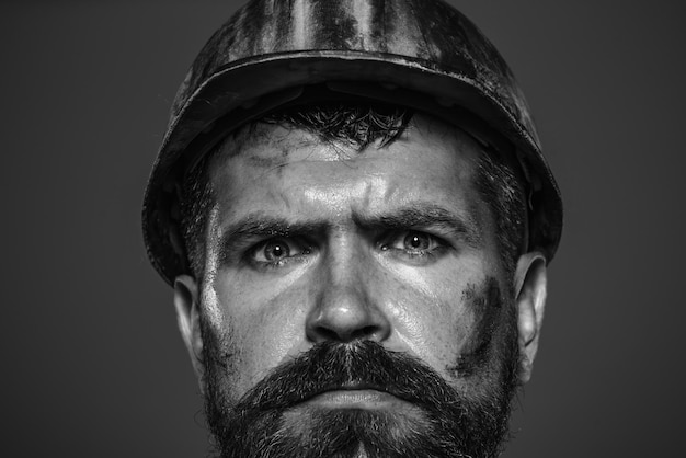 Industrial worker portrait architect builder on construction site portrait bearded man with protect