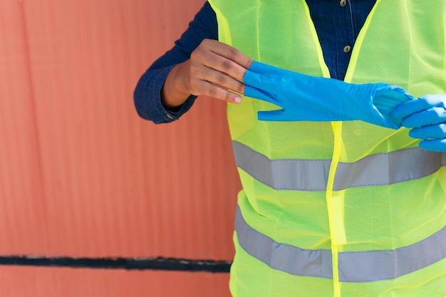 Industriearbeider die haar handschoenen uittrekt