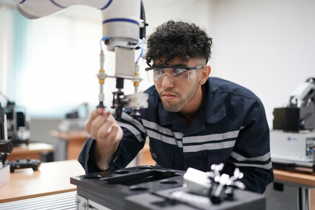 Industry 40 Young engineer works at a robotic arm