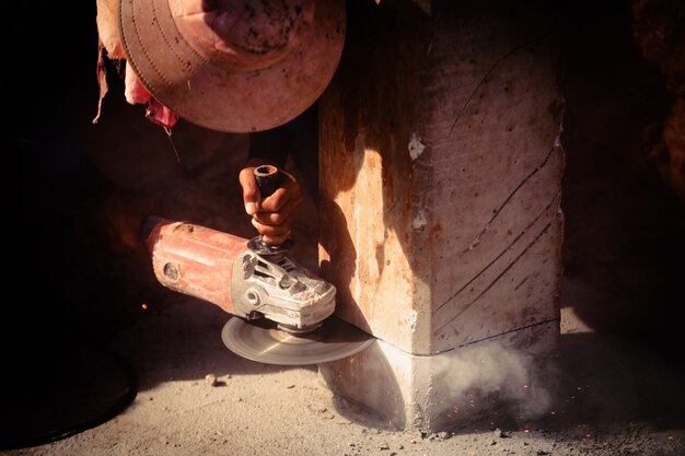 Industry construction labor men worker holding electric saw cuting concrete