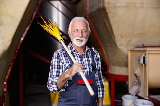 Photo industry worker cleans the factory