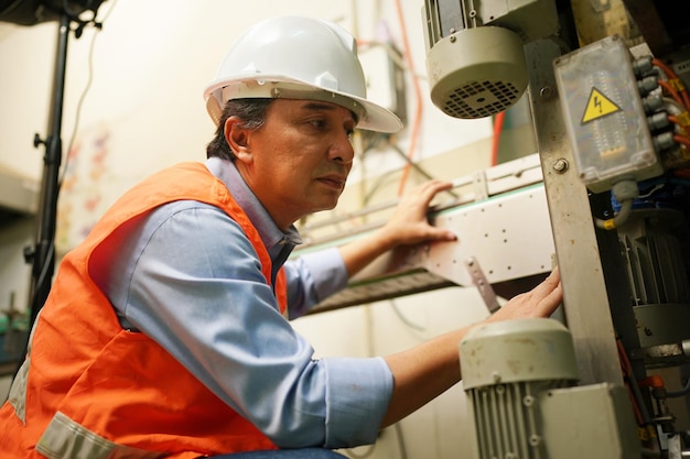 Industry worker entering data in cnc machine at factory