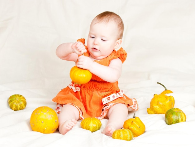 Infant with pumpkins