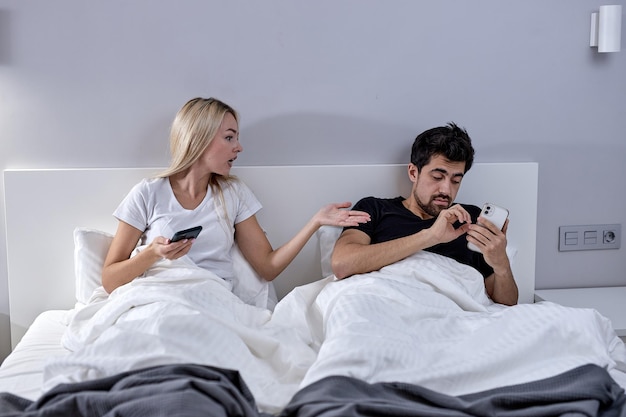 Infidelity. Cheating Man Texting On Phone With Lover Ignoring Unhappy Jealous Wife