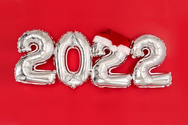 inflatable balloons on red background santa hat