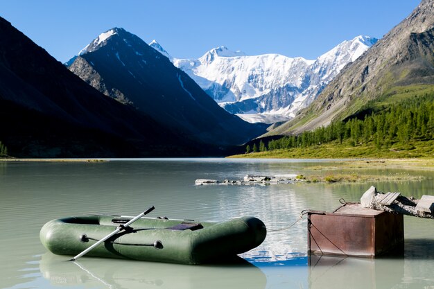 Inflatable boat at the lake shore in the mountains.