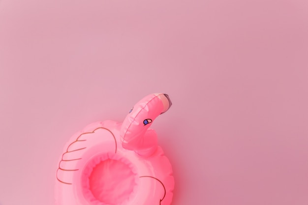 Inflatable flamingo isolated on pastel pink background