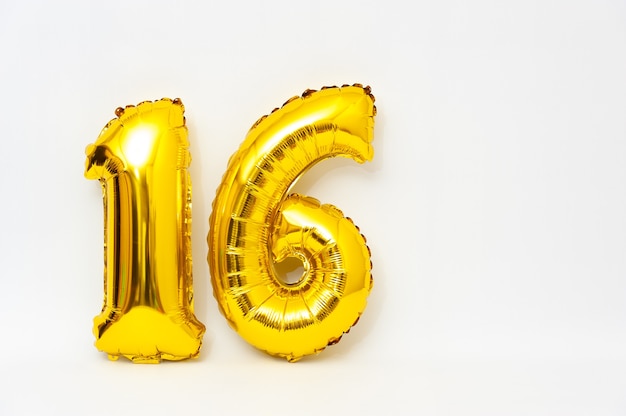 Inflatable numeral 16 sparkling metallic golden color isolated on white background