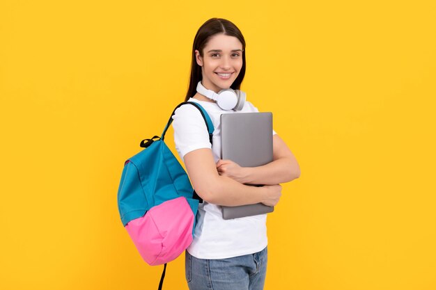 Influencer blogging cheerful girl with backpack and headphones